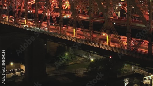 Night view of a busy bridge in New York with cars passing underneath