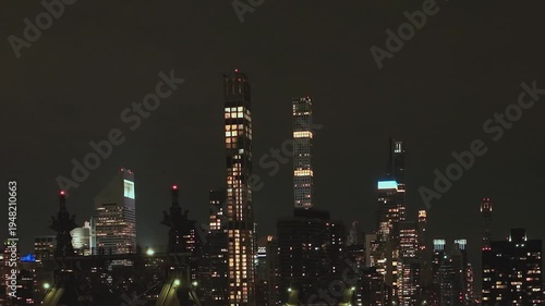 Night view of New York City skyline showing tall buildings and lights