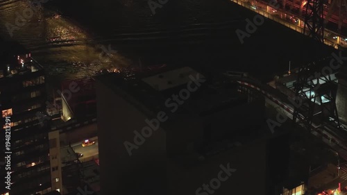 Light glimmers on water at night above New York cityscape
