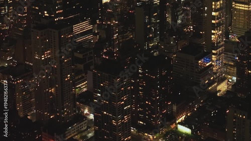 The scene shows buildings in New York lit up at night