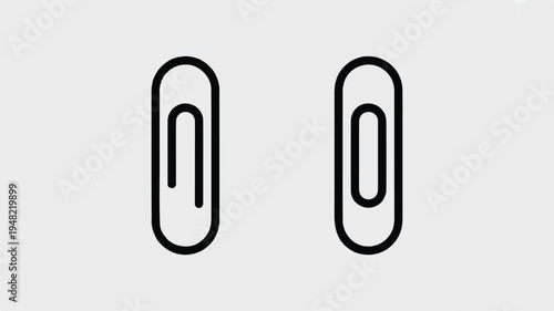 Two black paper clips on light gray background