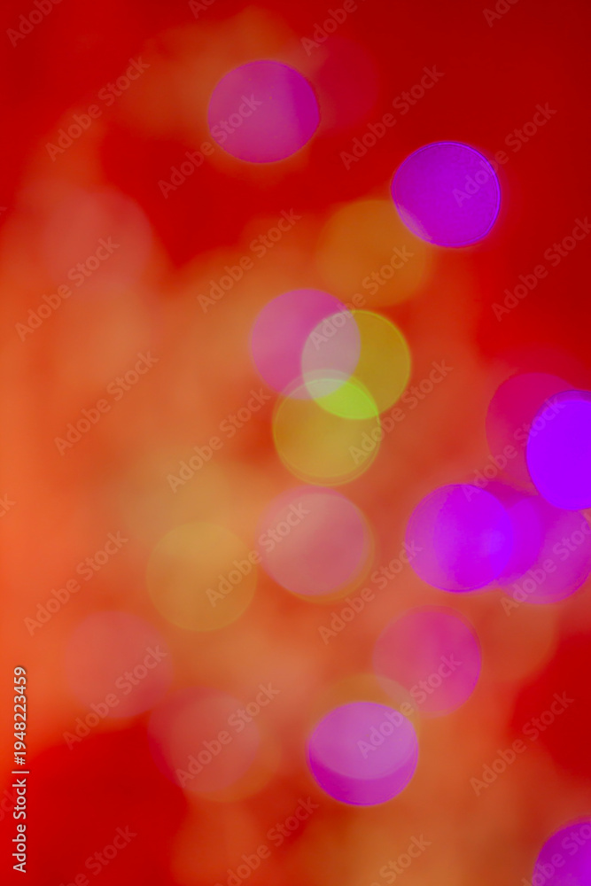 Obraz premium Abstract multicolored bokeh light circles softly blurred over a vivid red background, creating a vibrant and festive atmosphere.