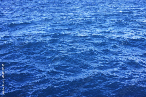 Blue ocean water surface texture with gentle waves