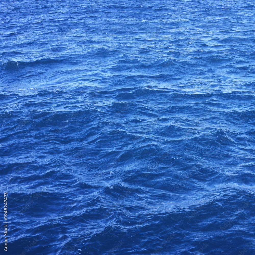 Obraz premium Blue ocean water surface texture with gentle waves