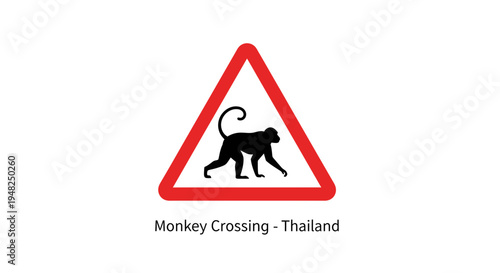Clearly visible warning sign featuring a monkey silhouette, alerting drivers to potential wildlife crossings and emphasizing road safety in natural environments
