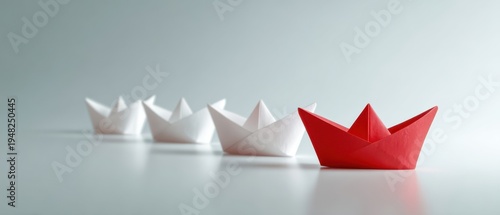 The red paper boat leading a line of white boats symbolizing leadership and teamwork