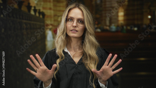 Tableau sur toile Woman hands gesturing religious young blonde judge uniform church indoors create a powerful image of ceremonial discourse captured on film