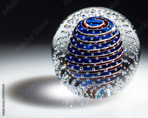 Photography glass paperweight with bubbles and blue and red spiral