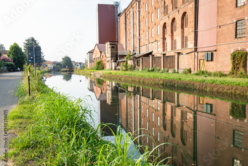 Photography reflection of a factory in the Naviglio Pavese canal at Certosa di Pavia, provin