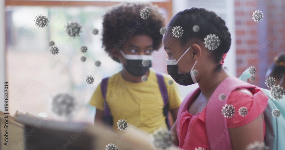 Obraz premium Standing two students wearing face masks at school counter, showing pink backpack and virus overlay