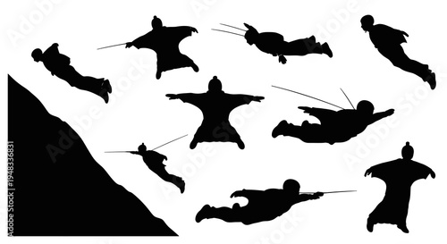 Black silhouette of wing-suited skydivers in dynamic flight poses