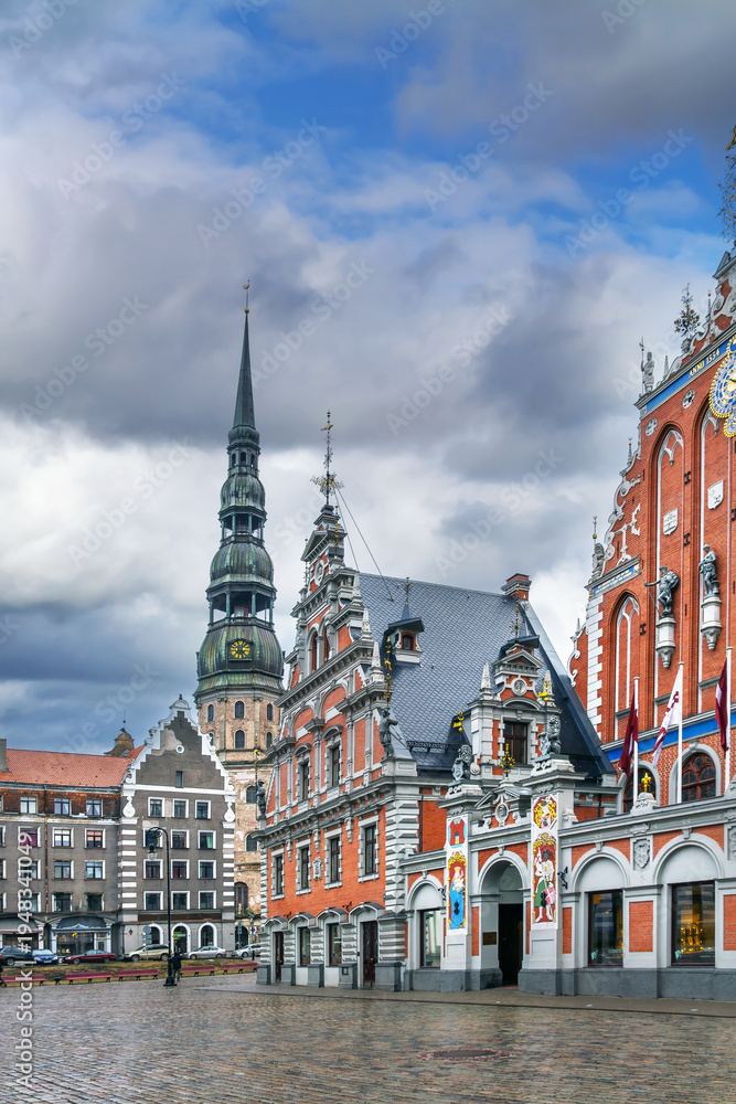 Fototapeta premium Town Hall Square with House of the Blackheads and St Peters Church tower, Riga, Latvia. Historic architecture in winter