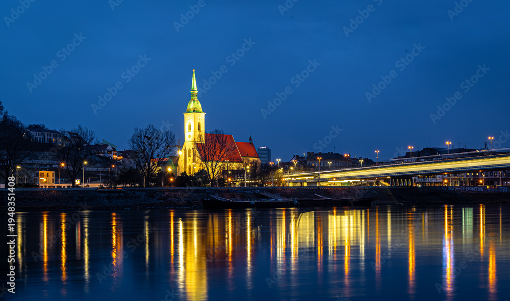 Obraz premium Bratislava night skyline with St Martins Cathedral bridge and reflections