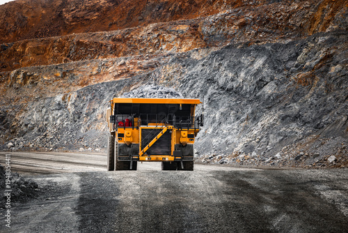 Obraz na płótnie Open pit mine industry, big yellow mining truck for gold ore