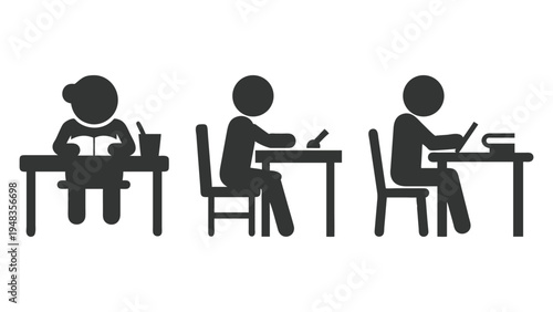 Three people sitting at desks working on papers and books together