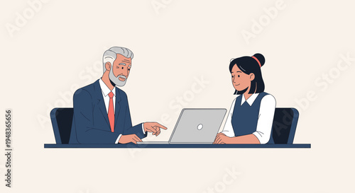 An older businessman in a suit points at a laptop screen while a younger female colleague attentively watches him at a desk.