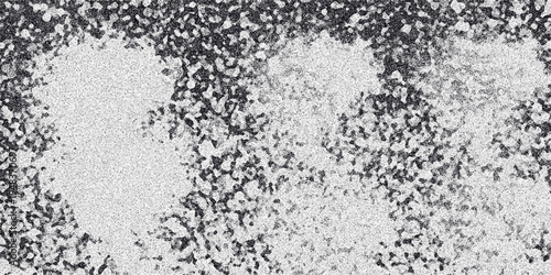 Abstract monochrome background with scattered light speckled patches against a dark grainy textured surface creating a diffused and atmospheric visual effect