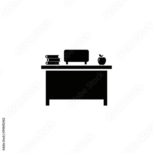 Desk with books computer and apple.