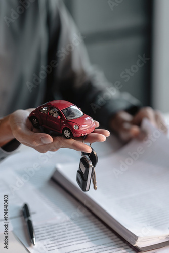 Businessman agent holding car keys offering new car salesman Automobile Vehicles Concept