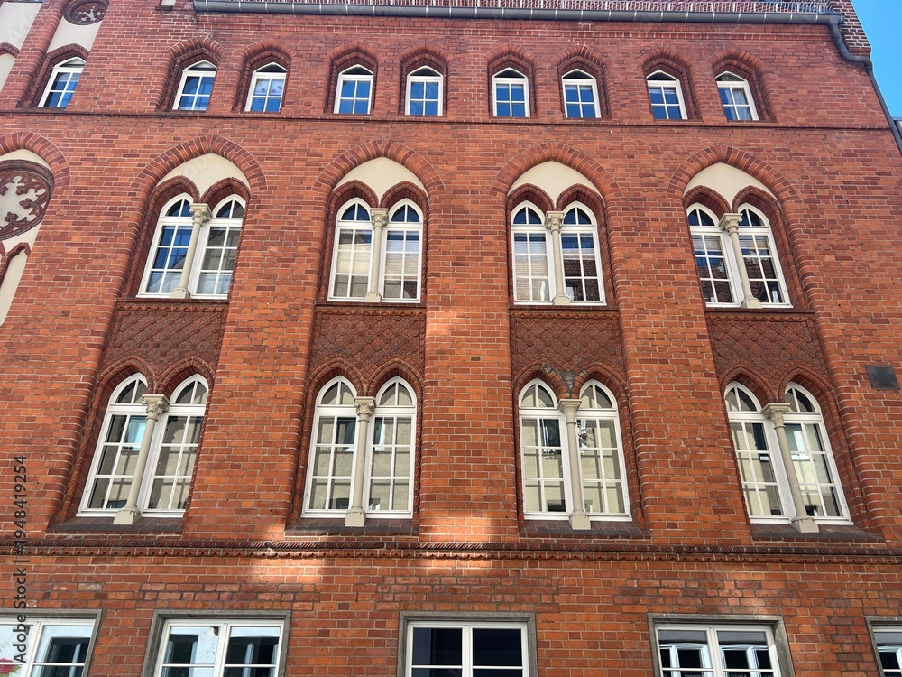 Fototapeta premium Arched windows on the side of a brick building