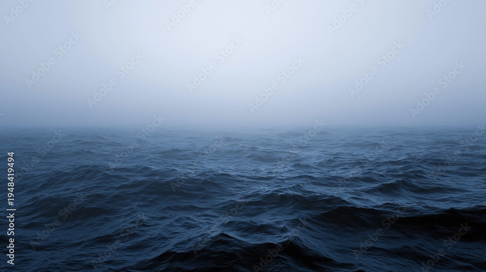 Obraz premium Serene mystery of the deep: dark navy blue sea waves under a thick, ethereal fog at dawn, perfect for moody backgrounds and contemplative nature-themed designs.