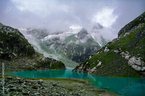Serene Tulian Lake, Pahalgam, Kashmir Surrounded by Misty Mountains and Cloudy Sky