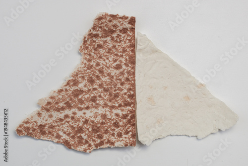 Pieces of dismembered lavash of brown color, dough products.