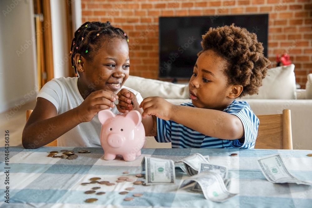 Fototapeta premium Children saving money together happily.