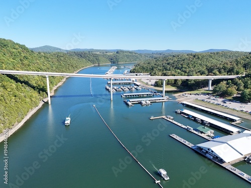 Wallpaper Mural Aerial View of the Lakeside Sunset Marina Resort on Dale Hollow Lake With Highway 111 Bridge, Boats and Forested Shoreline, Calm Water on a Sunny Day, Monroe, Tennessee, USA. Torontodigital.ca