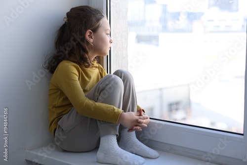 Free Download Autism. Little girl looking out window indoors - GFXLoad