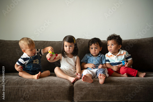 Photos Adorable toddlers sitting together.