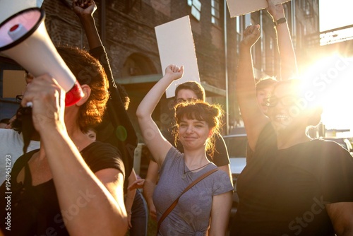 Joyful protestors rallying at sunset.