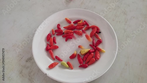 Red chili peppers on a white plate formation video footage