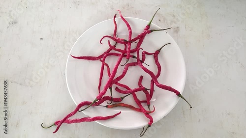 Red chili pepper on white plate