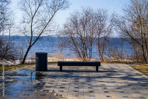 Bench by the Sea with Spring Ice – Coastal Landscape