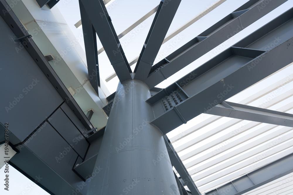 Fototapeta premium Steel structural column with intersecting truss bracing system in modern industrial architecture