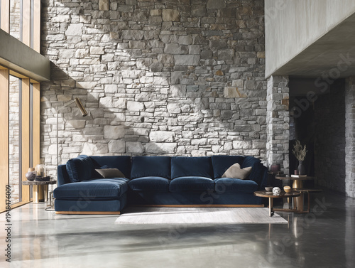 Luxurious navy blue sectional sofa with wooden frame, set against a rustic stone wall and minimalist decor