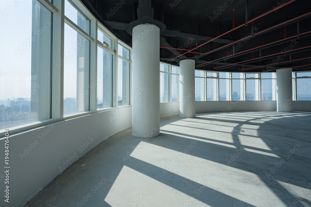 Fototapeta premium Spacious empty office interior with large windows and abundant natural light