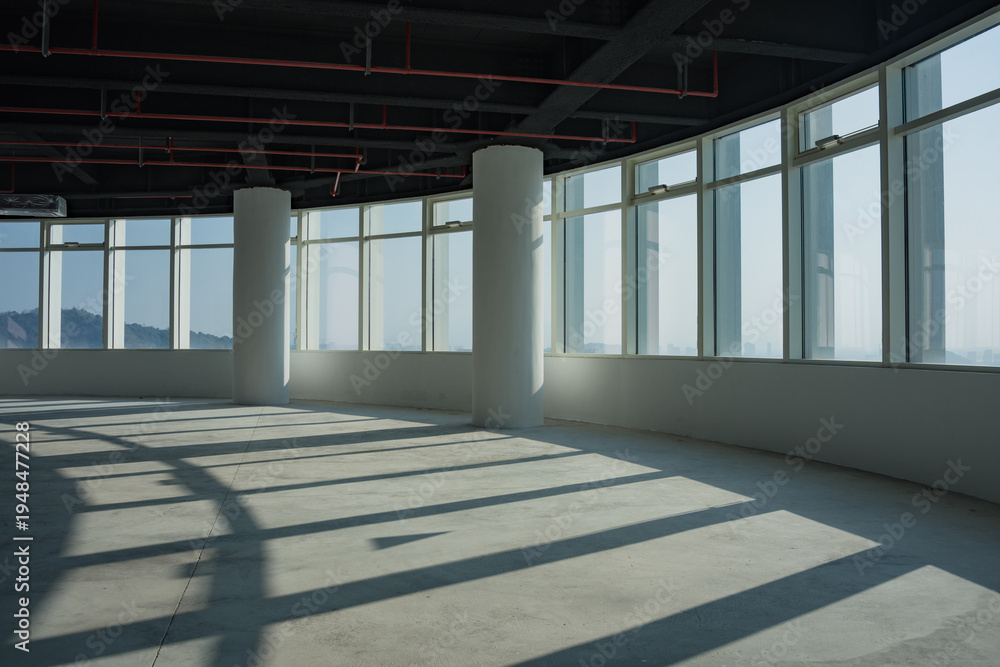 Fototapeta premium Spacious office interior with large windows allowing natural light and mountain views