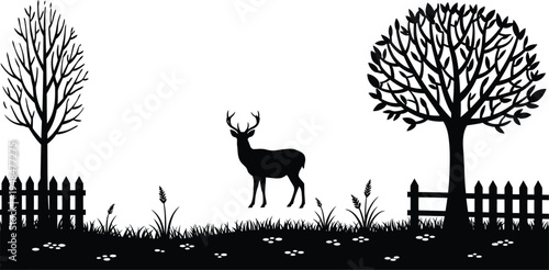 Deer standing between two trees and a wooden fence in a field
