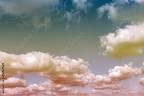 Unusual pink clouds drift across a blue sky