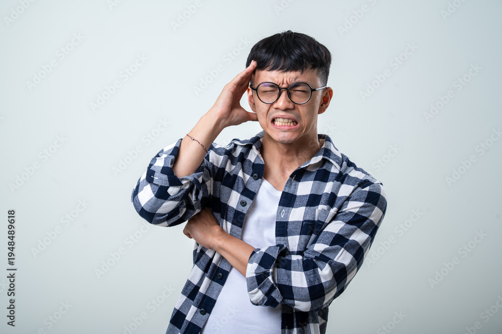 Ταπετσαρία Young Asian man wearing round glasses, plaid shirt, and white tank top holds his
