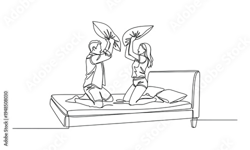 Two people sitting on a bed with a plant