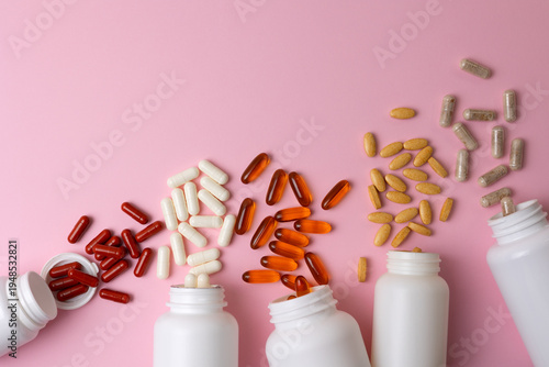 Vitamins On Neutral Background. Assorted Supplement Bottles With Capsules On Plain Backdrop