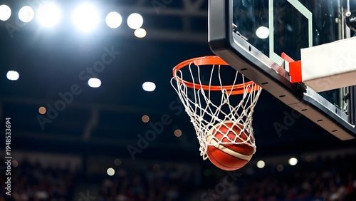 Scoring during a basketball game ball in hoop.