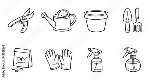 Garden hand tools and accessories arranged on gray background