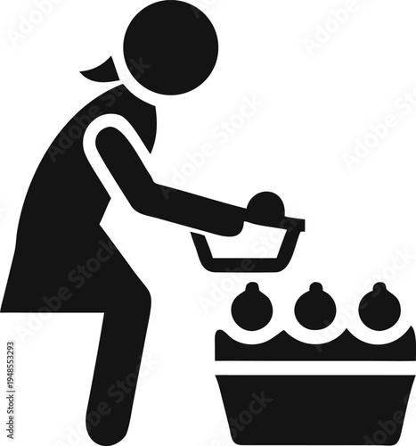 Woman selecting fresh produce and placing it into her shopping basket from a large crate