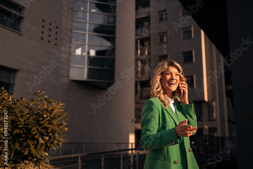 Foto Successful woman talking on phone laughing urban setting