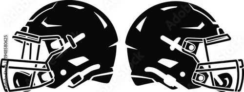 Two black football helmets with faceguards facing each other