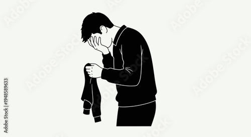 Man in despair, holding a crumpled shirt, head in hands, isolated on a light background